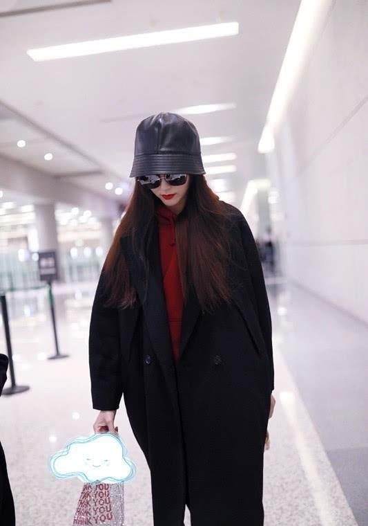 唐嫣穿一件黑色风衣出门,配上大红色卫衣,这俩